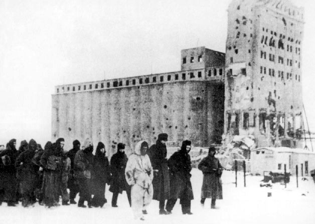 German soldiers as prisoners of war. In the background is the heavily fought-over Stalingrad grain elevator