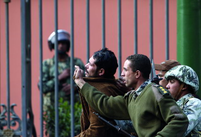 Egyptian soldiers arrest a suspected looter near the Cairo Museum, Jaunary 30th, 2011