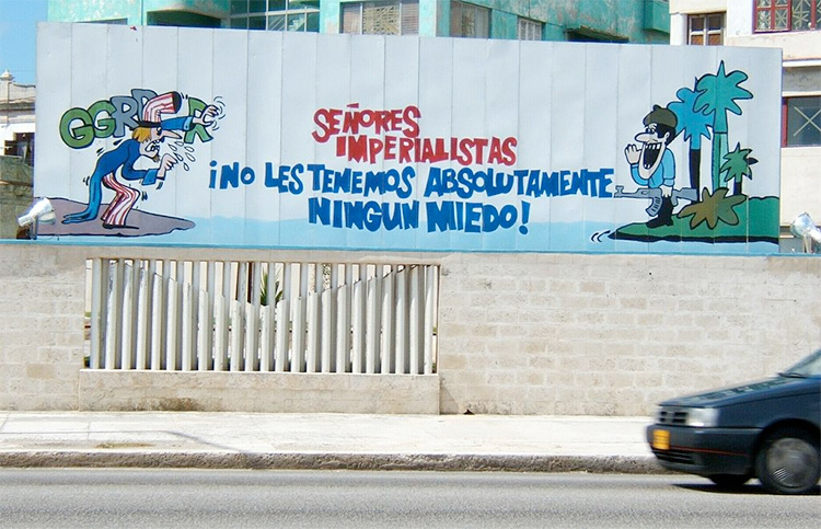 Cuban propaganda poster in Havana featuring a Cuban soldier addressing a threatening Uncle Sam. Photo by KPu3uC B Poccuu