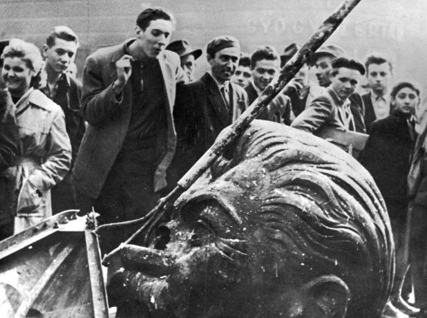 A crowd surround the demolished head of a statue of Stalin during the Hungarian Revolt, Budapest, 1956. (Getty Images / Hulton Archive)