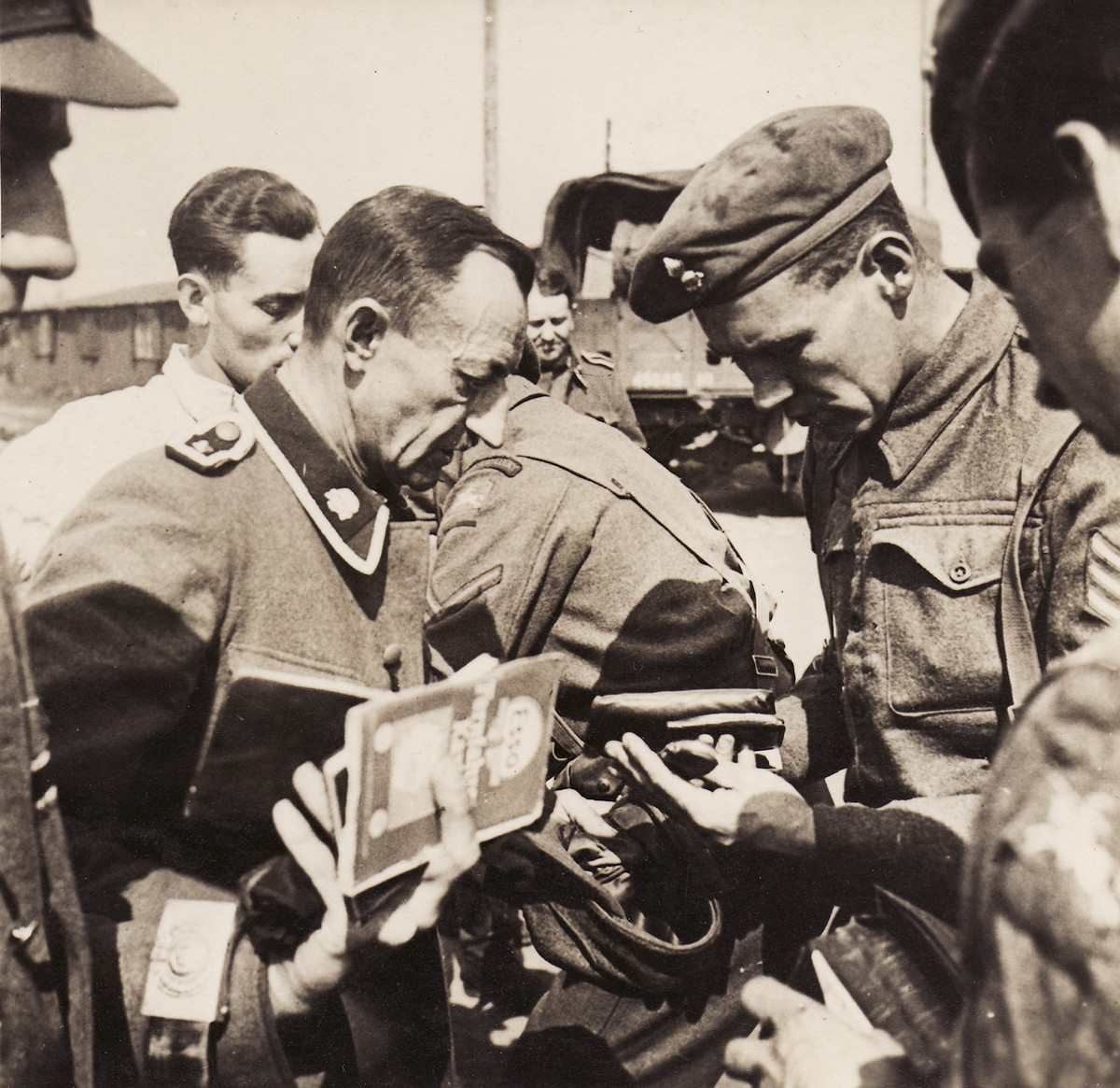 British soldiers inspect the documents of former SS guards at Bergen-Belsen concentration camp, 15 April 1943. United States Holocaust Memorial Museum.