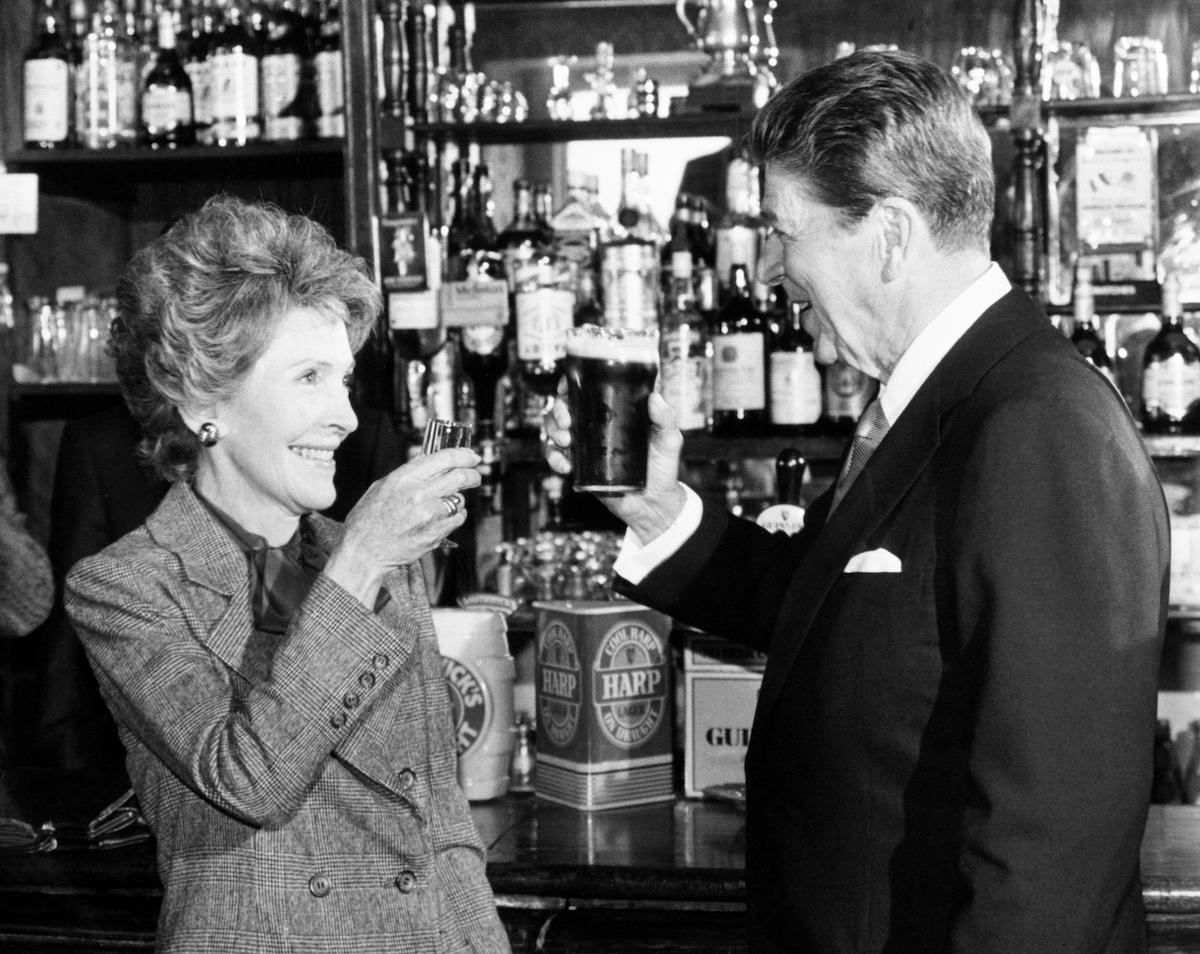 President Ronald Reagan and wife Nancy toast each other at the bar of O'Farrell's Pub in Ballyporeen, while on a four day visit to the Republic of Ireland, 3 June 1984. PA Images/Alamy Stock Photo.