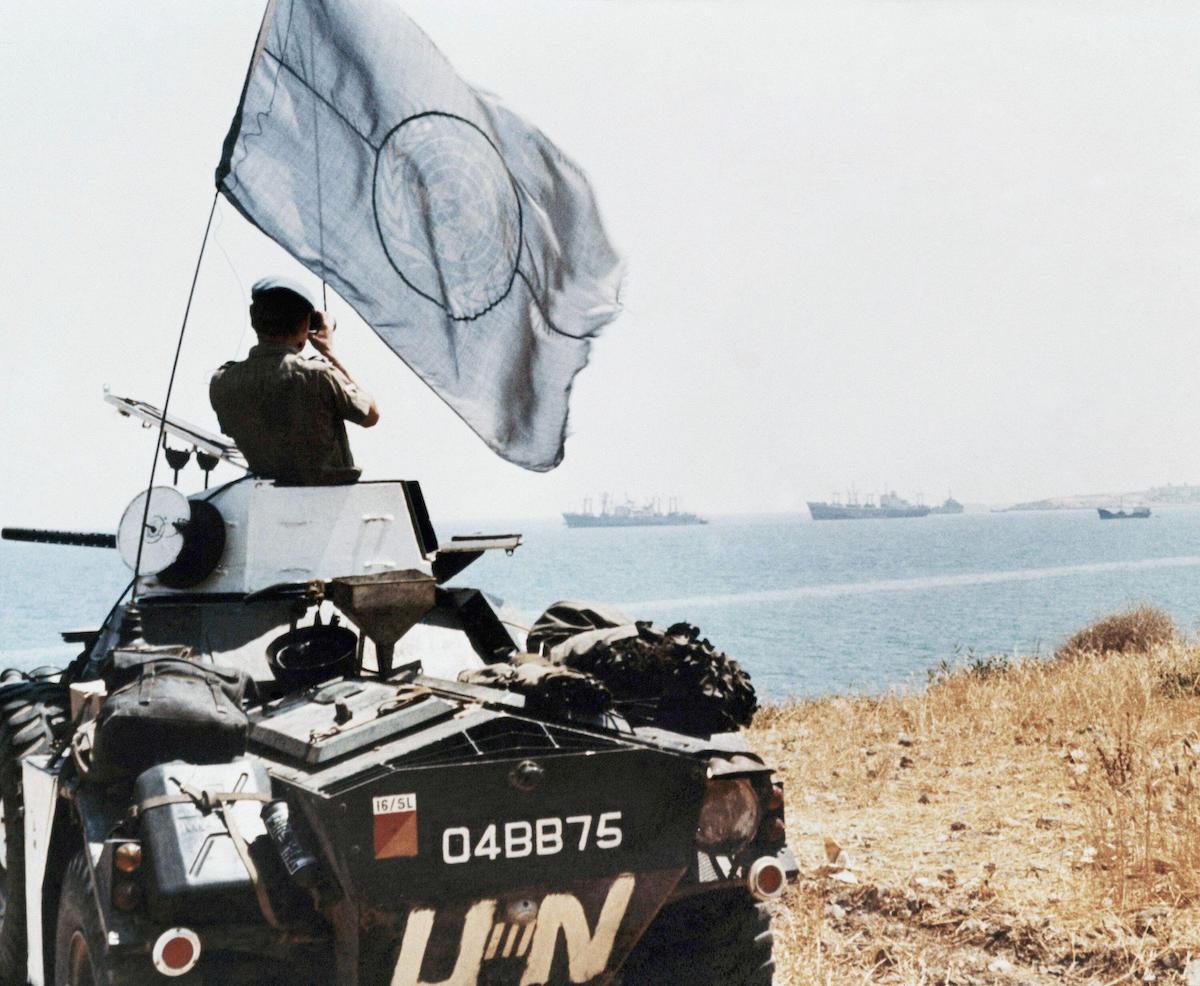 A United Nations trooper observes Turkish ship movements near Karavas, Cyprus, 4 August 1974. Associated Press/Alamy Stock Photo.