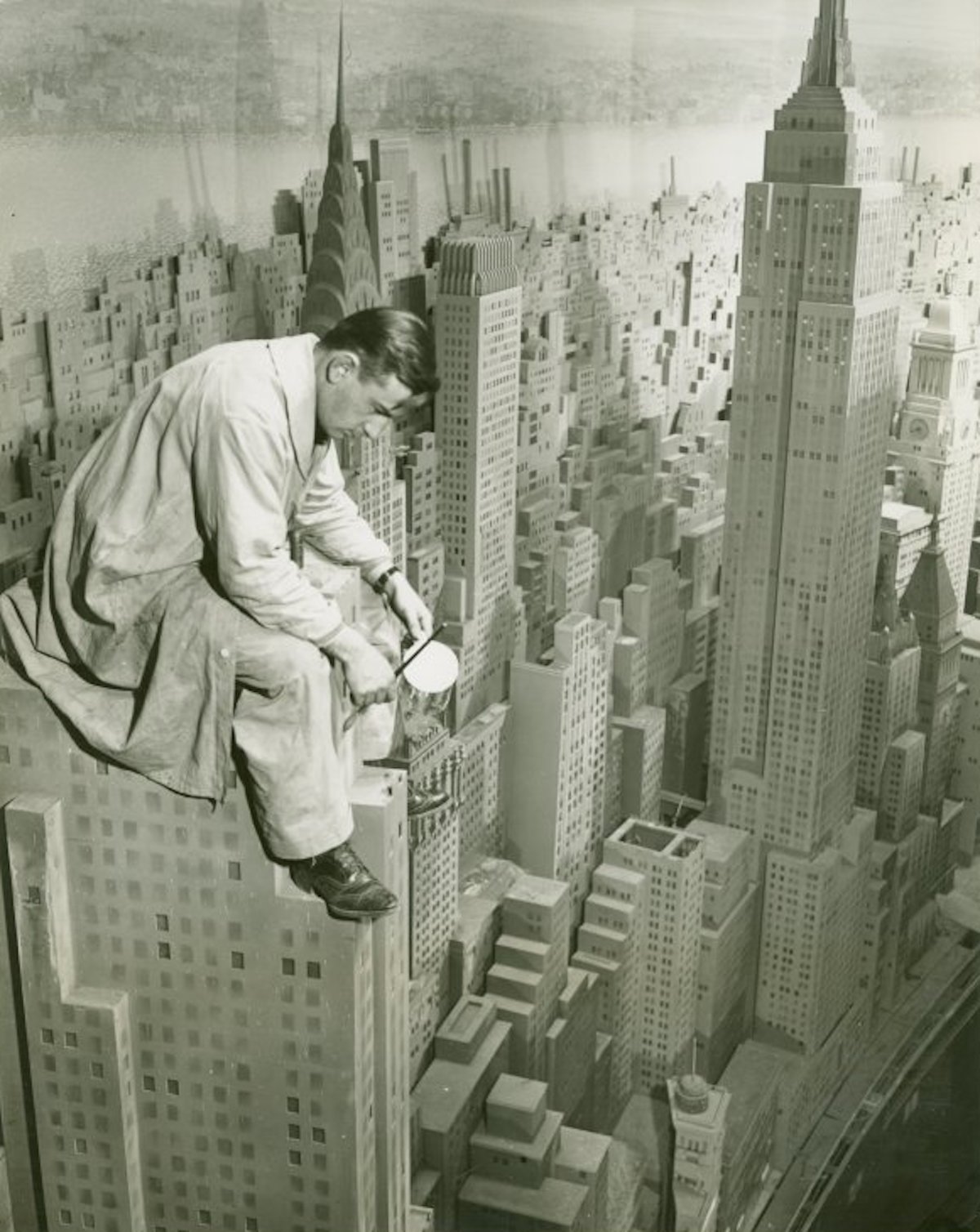 A painter at work on the 4,000-building Edison – City of Light diorama at the New York World’s Fair, 1940. New York Public Library. Public Domain.