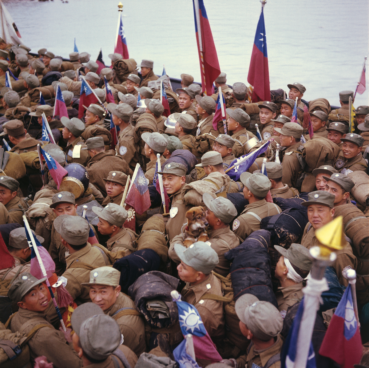 Chinese POWs headed for Taiwan, some of whom hold the flag of the Republic of China, the Nationalist government of Taiwan, 20 January 1954. Bettman/Getty Images.