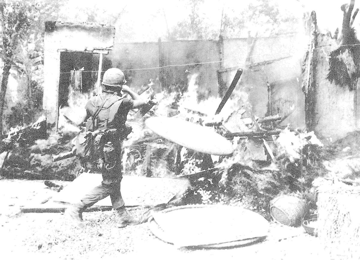 A US soldier sets a building alight on 16 March 1968, by Ronald L. Haeberle, from Report of the Department of the Army Review of the Preliminary Investigations Into the My Lai Incident - Volume III. Library of Congress. Public Domain.