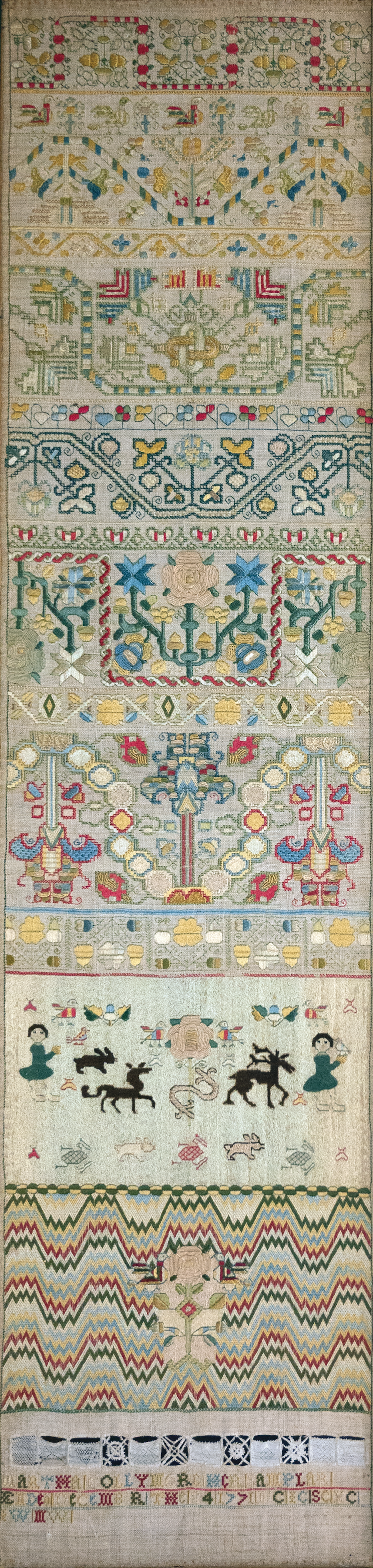 Martha Collymore’s sampler, detail showing her inscription (bottom) below the rose flanked  by birds, Barbados, 1771. Royal School of Needlework.