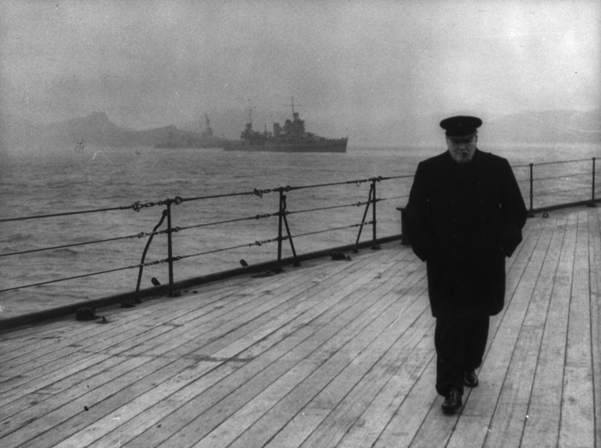 Prime minister Winston Churchill walks the deck of HMS Prince of Wales during the Atlantic Conference, 1941. Library of Congress. Public Domain.