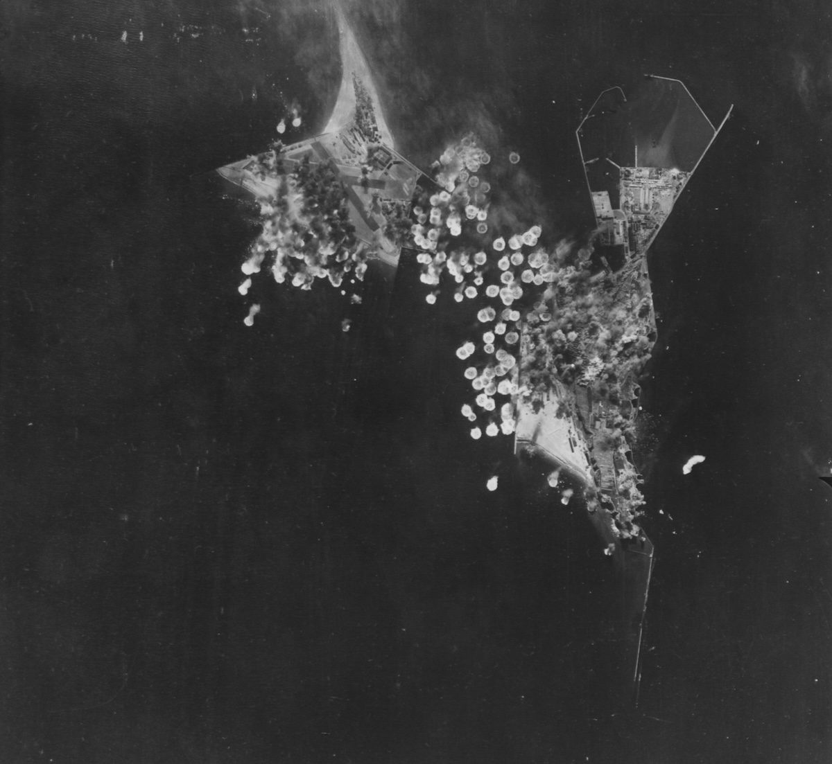 Bombs strike German military installations at Heligoland during a US air raid, 15 May 1943. US National Archives. Public Domain.