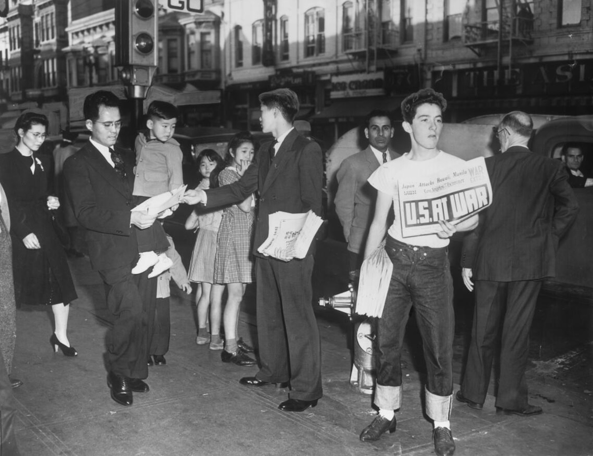 Newsboys in Little Tokyo, their papers carrying news of Pearl Harbor, 7 December 1941. University of Southern California.