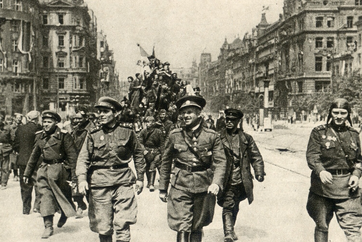 Two Red Army officers march onto Prague’s Wenceslas Square ahead of their tanks, 1945. Moravian Library in Brno. Public Domain.