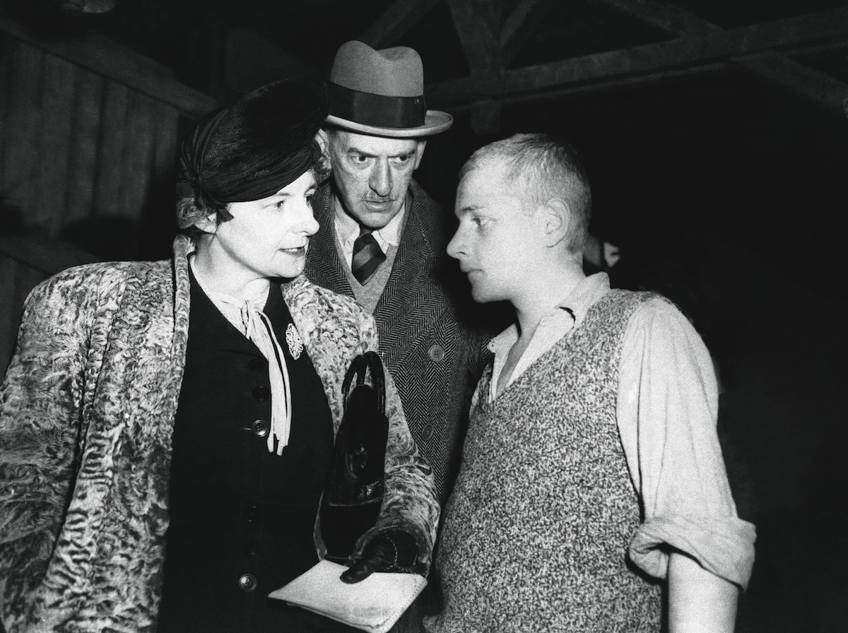 Mavis Tate and Edward Wickham talk with a young Czech survivor in the prisoners’ barracks at Buchenwald, April 1945. Associated Press/Alamy Stock Photo.