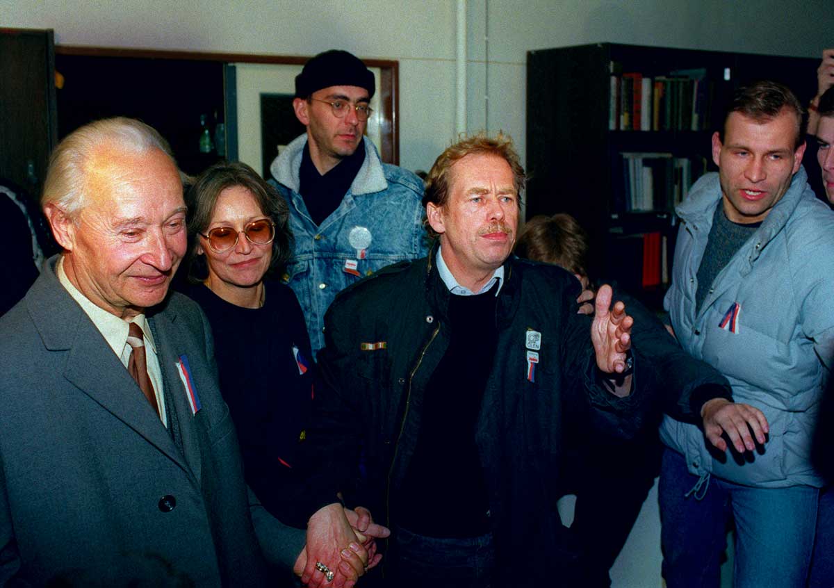 Alexander Dubček, Marta Kubišová and Václav Havel holding hands as they prepare to address demonstrators in Wenceslas Square,  24 November 1989 © Lubomir Kotek/AFP/Getty Images.