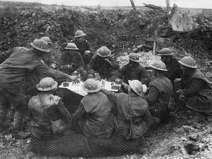 British soldiers share a Christmas meal in the trenches. National Library of Scotland. Public Domain.