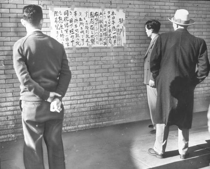 Japanese-Americans in Little Tokyo read a news bulletin, 8 December 1941. University of Southern California.