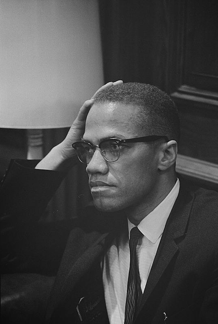 Malcolm X waits at Martin Luther King press conference, 26 march 1964. Library of Congress. Public Domain.