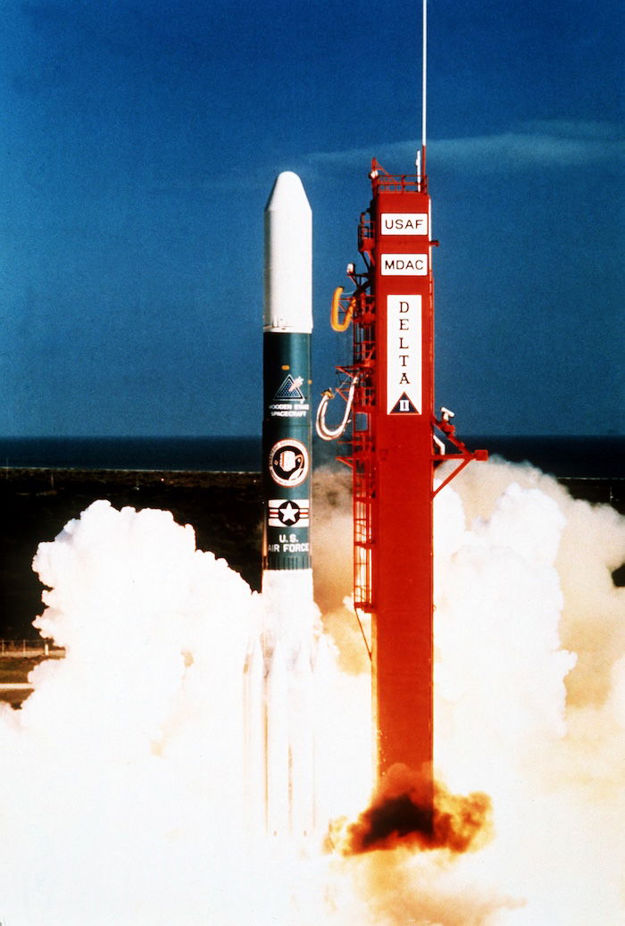 A Delta II rocket in the Strategic Defense Initiative program lifts off beside its launch tower, 29 September 1989. US National Archives and Records Administration. Public Domain.