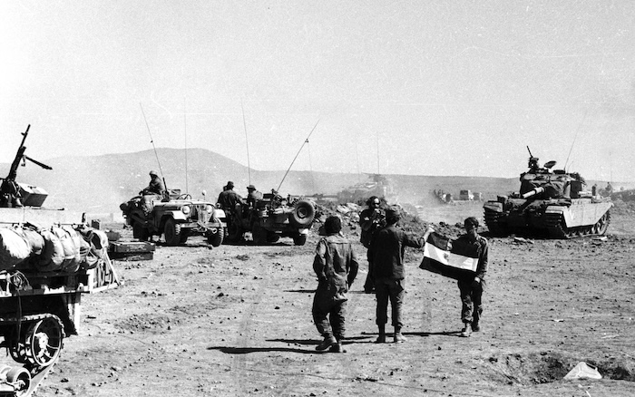 IDF soldiers hold a Syrian flag after a battle in the Yom Kippur War, 1973. National Library of Israel (CC BY).