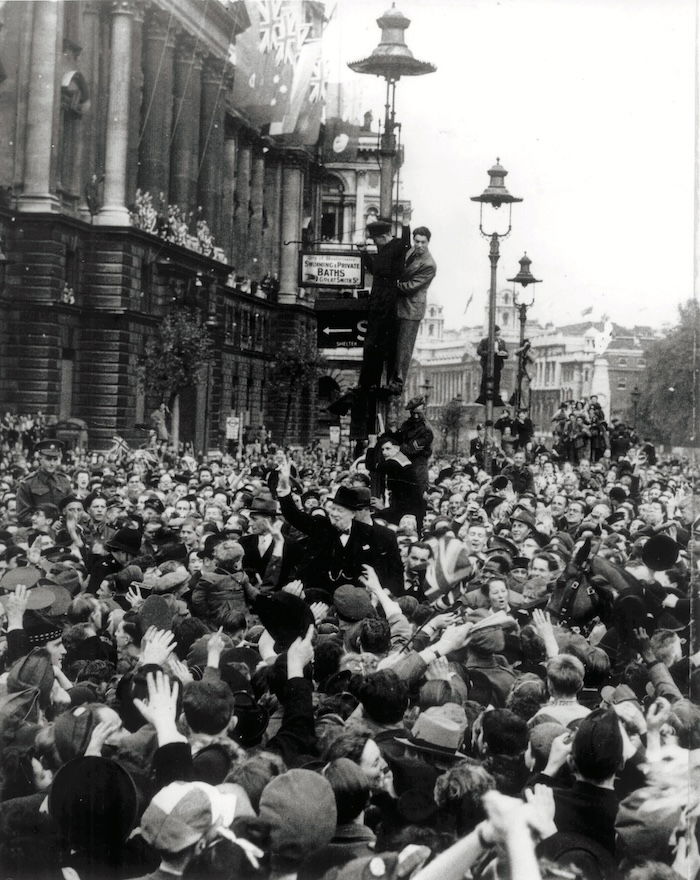 Winston Churchill and crowd on VE Day, outside the Ministry of Health, Whitehall. TopFoto.