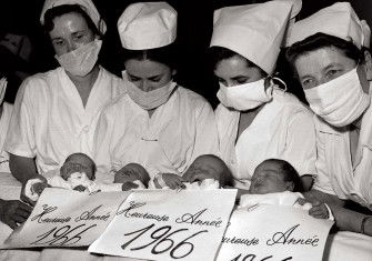 Nurses at the Baudelocque Maternity Hospital in Paris presenting babies born on New Year’s Eve, 1965 © AFP/Getty Images.