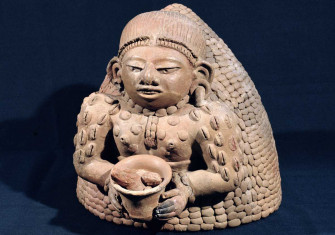 Woman holding cacao (and decorated with cacao beans), Maya, AD 250-450 © Bridgeman Images.