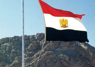 Anwar Sadat raises the Egyptian flag over Sinai, 26 May 1979. William Karel/Getty Images.