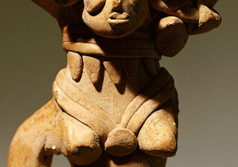 Terracotta figure with a headdress of flowers, rings and a belt, c.3000 BC.