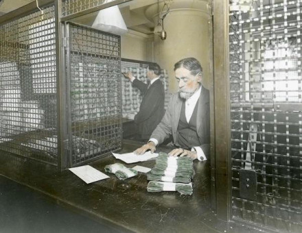 The receiving cashier’s cage at the US Treasury, to which money is returned after verification, late 19th-early 20th century. piemags/N23/Alamy Stock Photo.