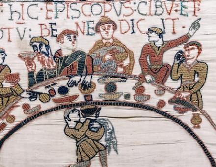 Bishop Odo blesses the food and wine, detail from the Bayeux Tapestry,  late 11th century. Bridgeman Images.